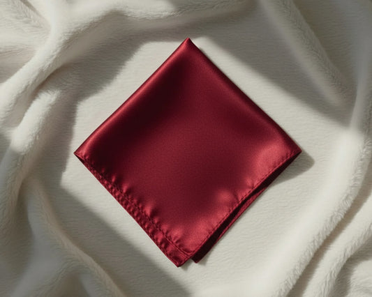 Red satin square on a textured white surface