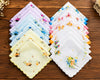 Set of floral ladies handkerchiefs on a wooden surface