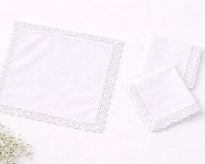 Two white lace trimmed pillows on a light gray background