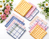Set of colorful checkered coasters with flowers on a white background