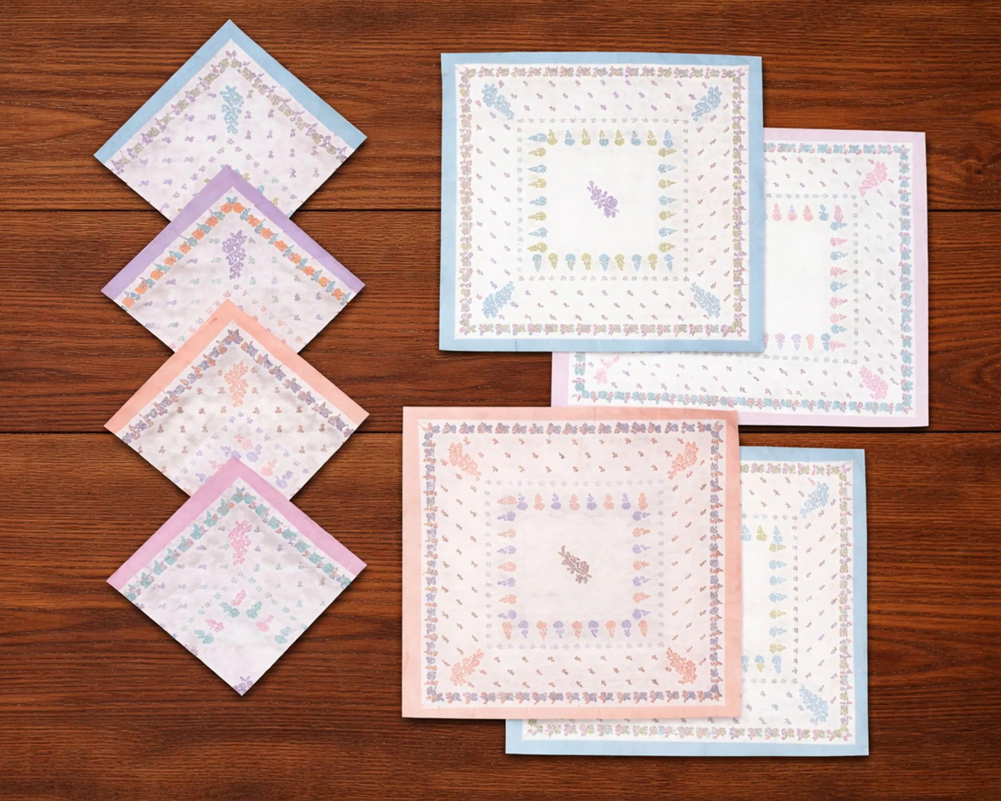 Set of baby blankets with patterns on a wooden surface