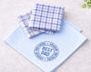 Set of blue and white checkered hanky with 'Best Dad' text on a light background