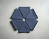 Set of blue checkered handkerchief arranged in a circular pattern on a light gray surface.
