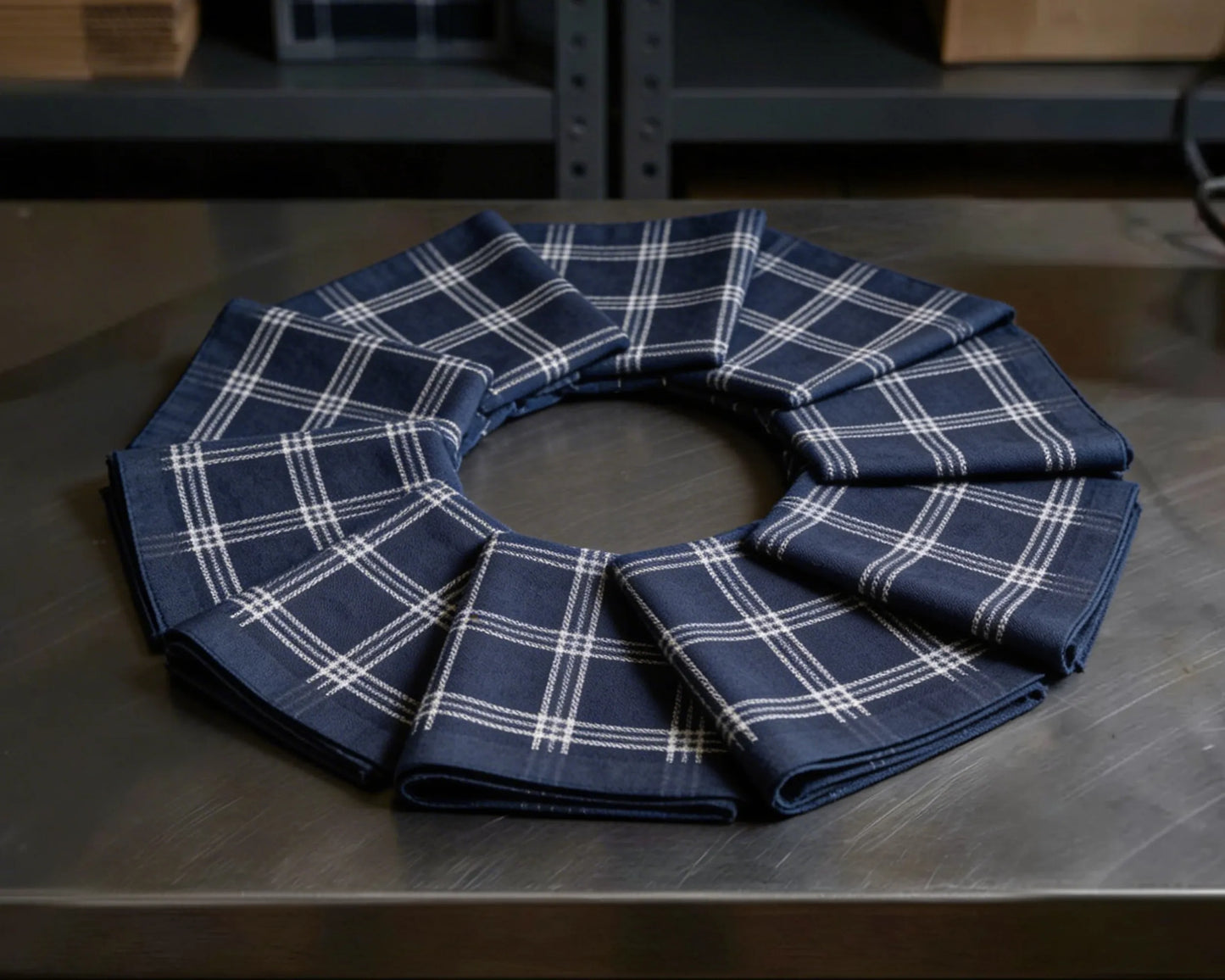 Set of blue plaid check hanky on a metallic surface