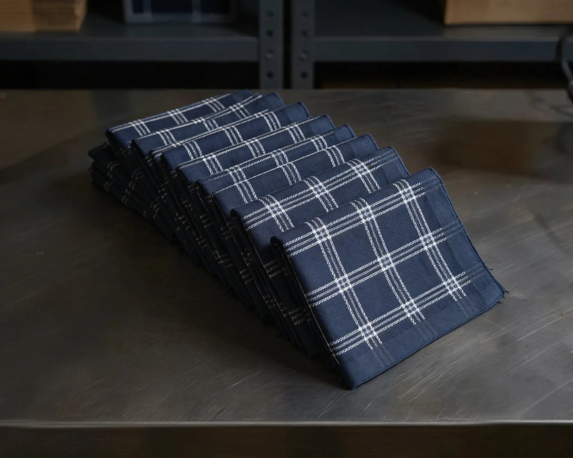 Set of blue plaid checked hanky on a wooden surface
