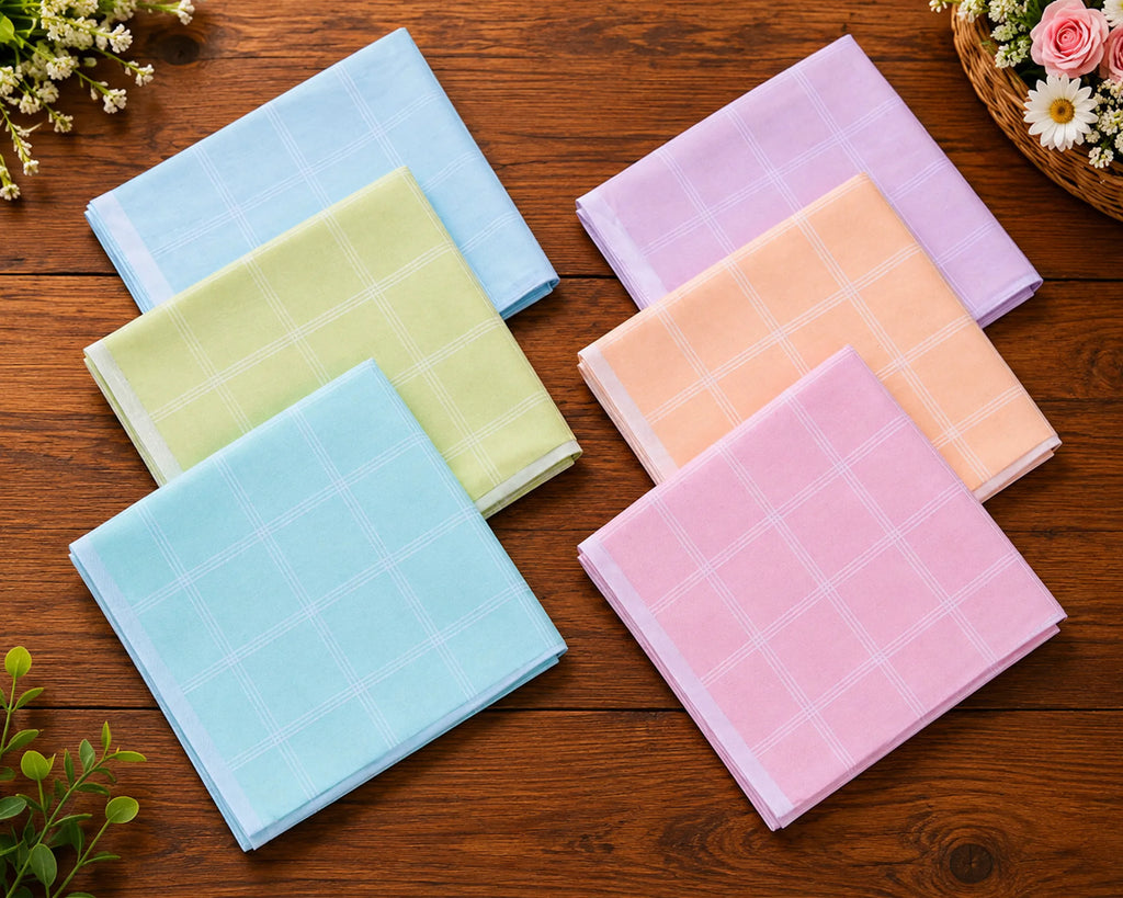 Set of colorful checkered hanky on a wooden surface with flowers around.
