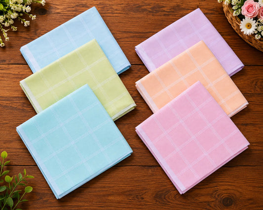 Set of colorful checkered hanky on a wooden surface with flowers around.