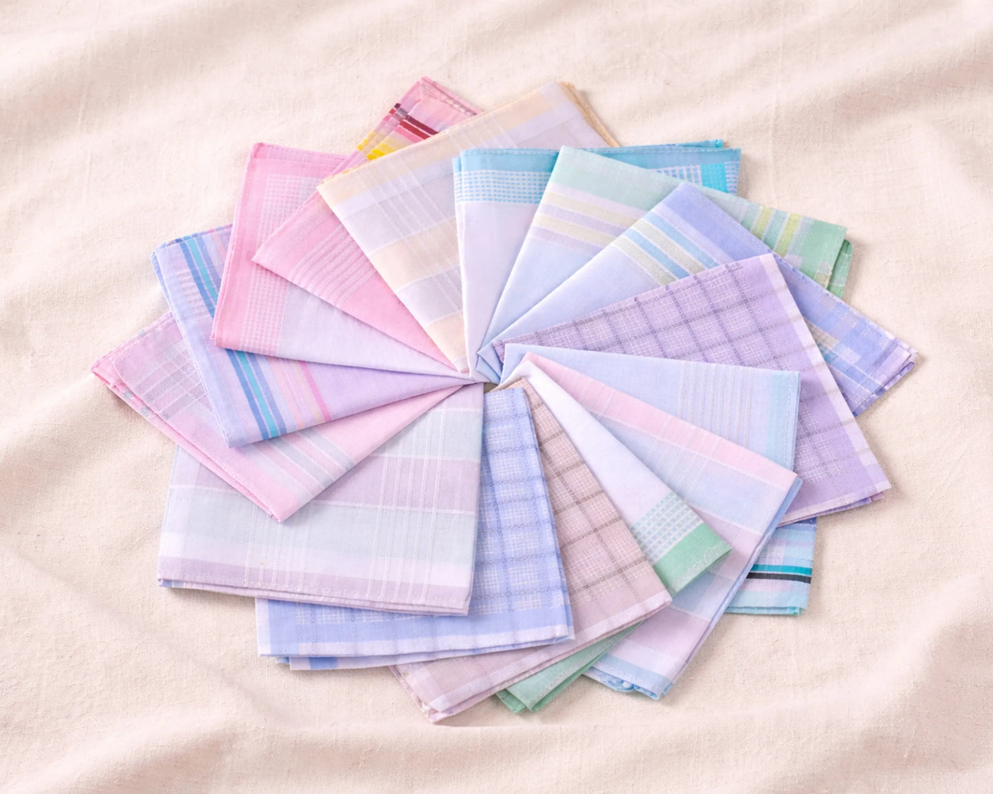 Set of colorful handkerchiefs arranged in a circular pattern on a beige background