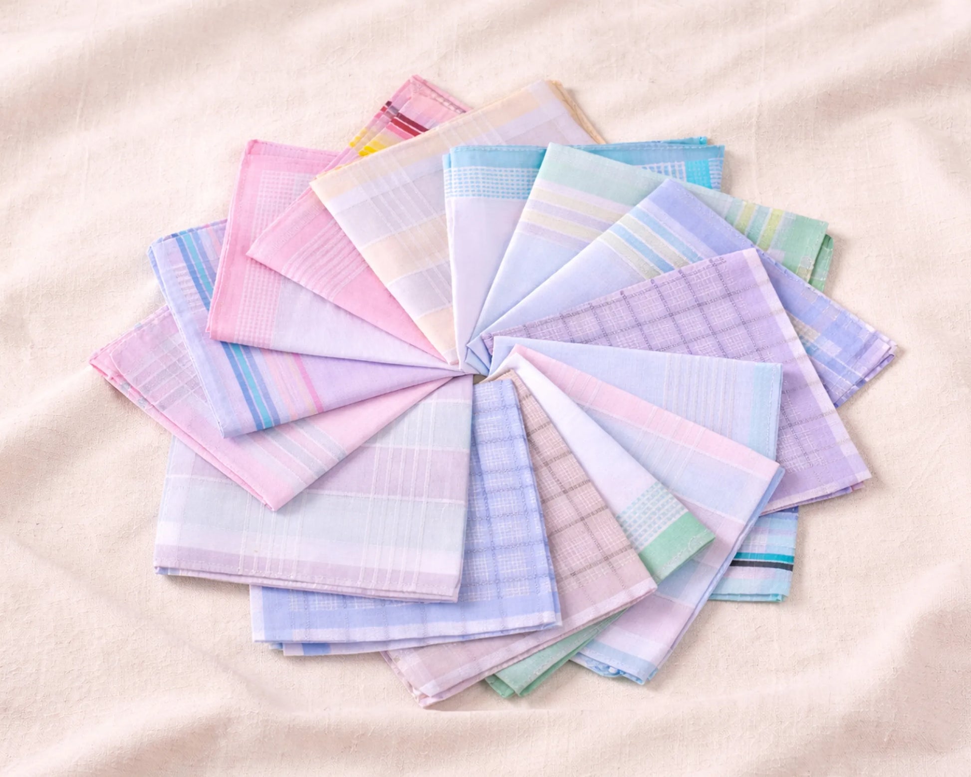 Set of colorful handkerchiefs arranged in a circular pattern on a beige background