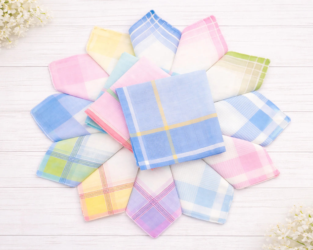 Set of colorful handkerchiefs on a white wooden surface with flowers.