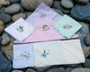 Set of embroidered handkerchiefs on a stone surface
