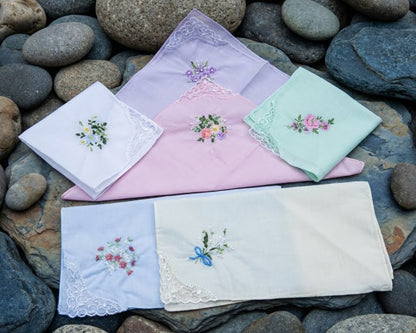 Set of embroidered handkerchiefs on a stone surface