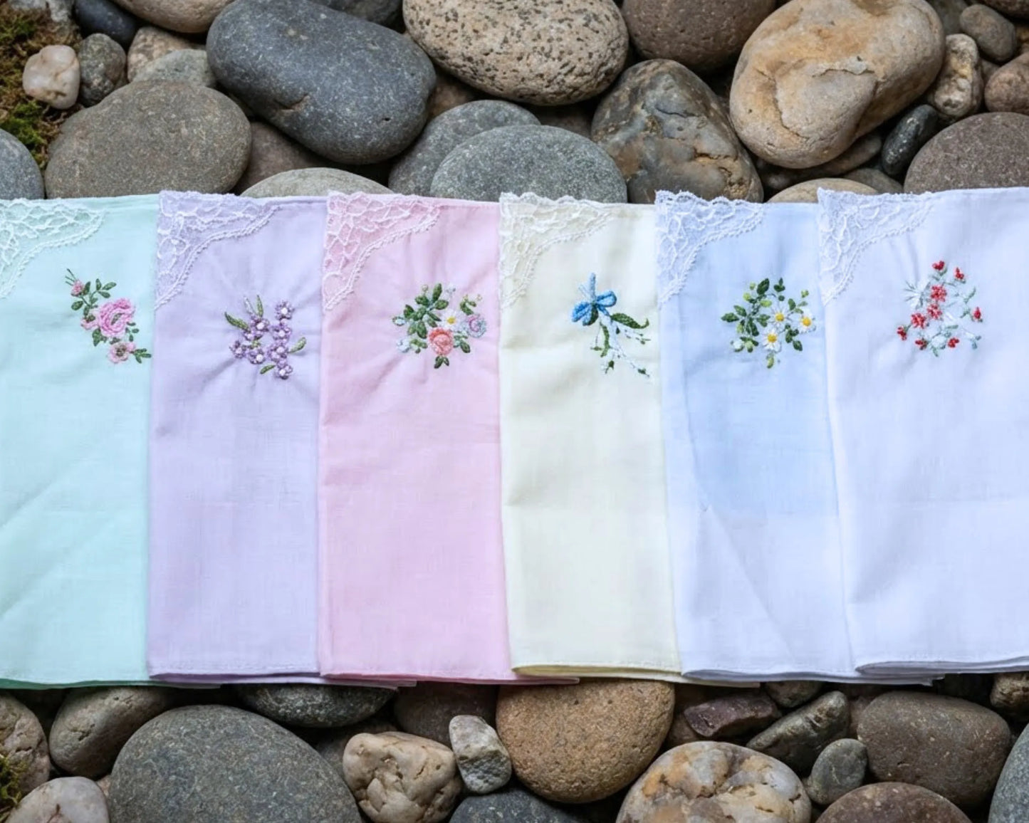 Set of embroidered handkerchiefs on a bed of stones