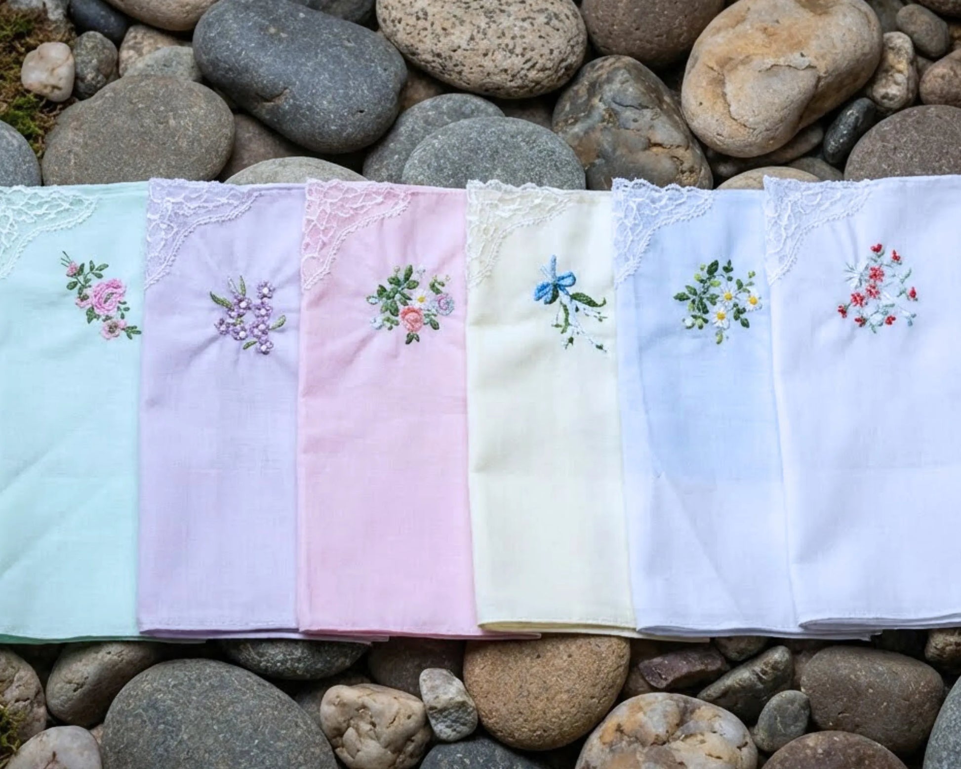 Set of embroidered handkerchiefs on a bed of stones