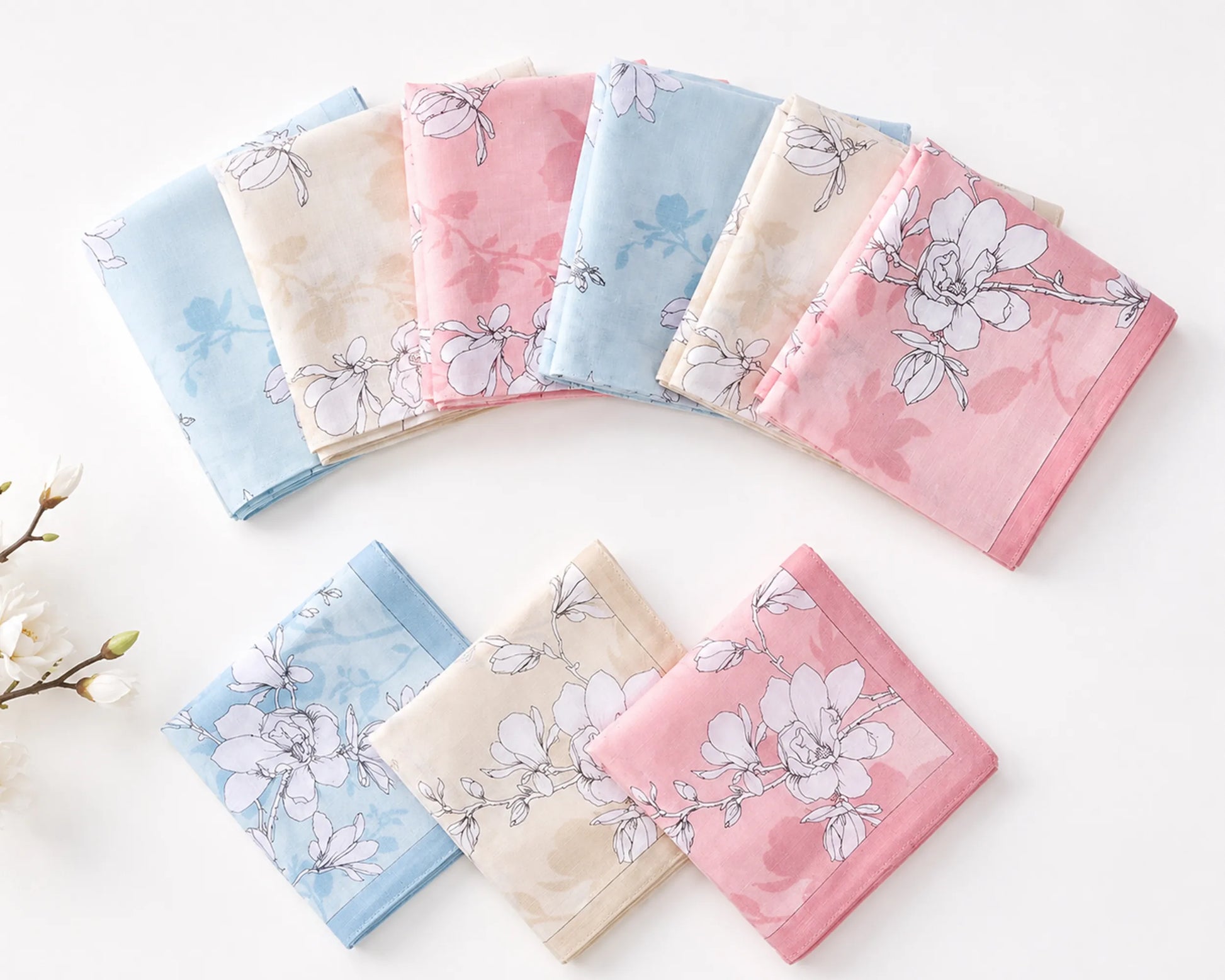 Set of floral-patterned handkerchiefs in pastel colors on a white background