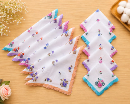 Set of floral printed handkerchiefs on a wooden surface with decorative elements.