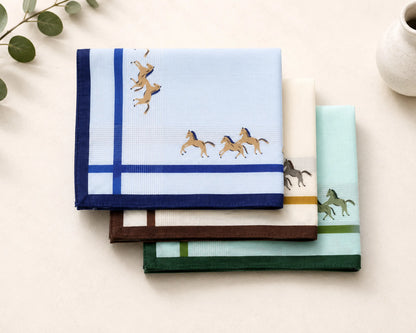 Set of folded cotton hanky with horse designs on a light surface.