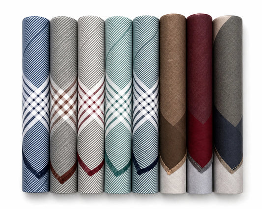 Set of folded fabric hanky in various patterns and colors on a white background
