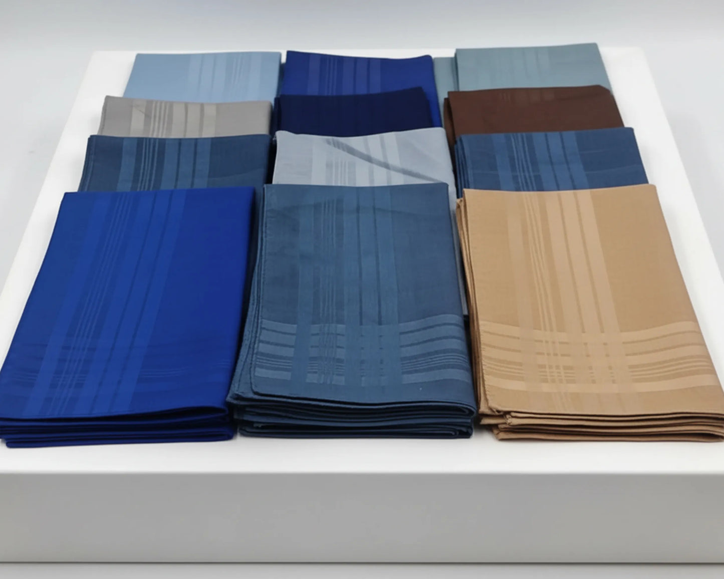 Set of folded handkerchief in various colors on a white background
