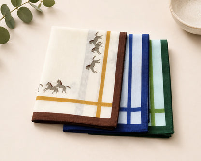 Set of folded hankie with animal designs on a light surface