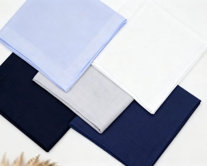 Set of folded hanky in blue, navy, and gray on a white background