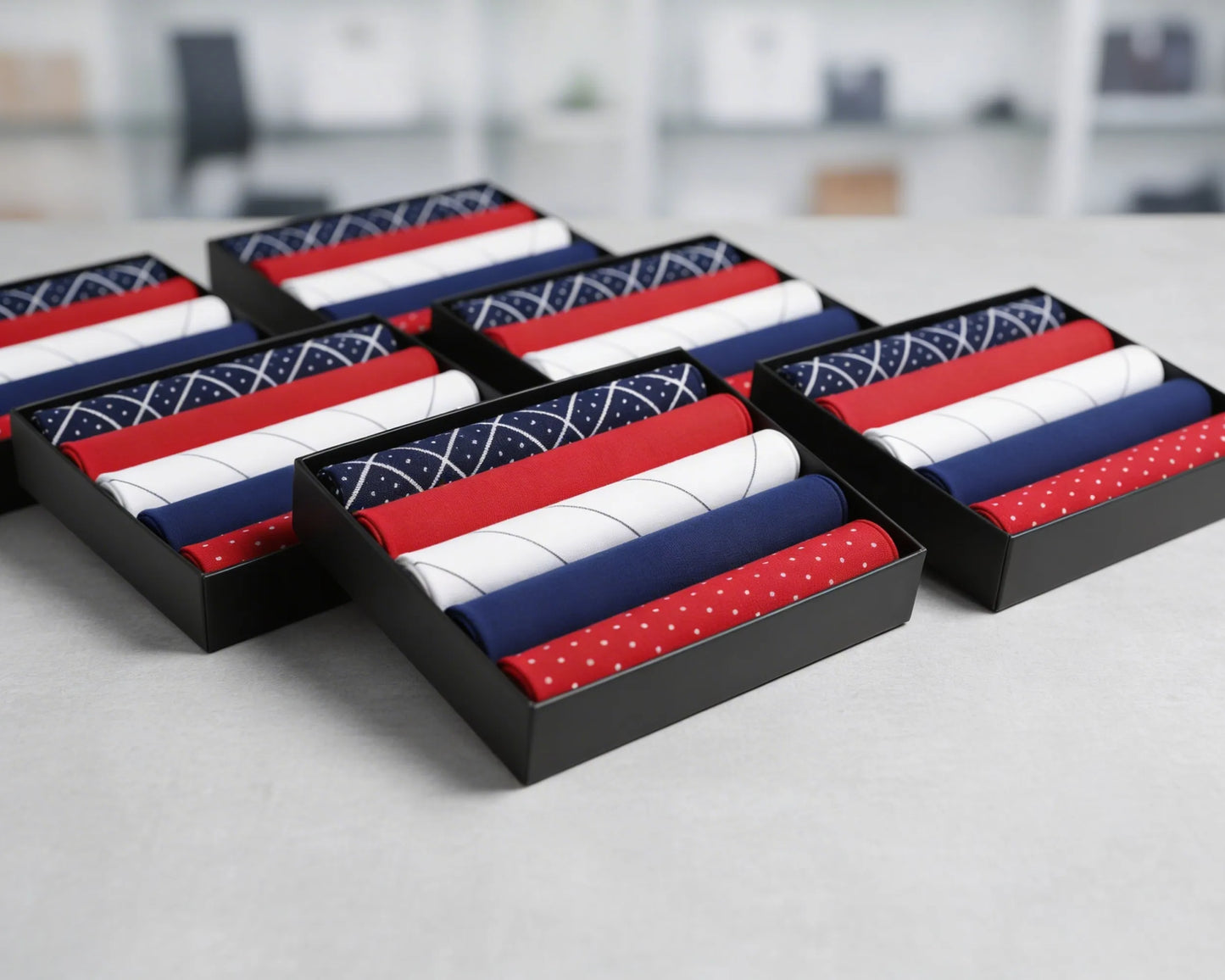 Set of folded hanky in red, white, and blue packaging on a blurred indoor background