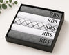 Set of folded hanky with 'RBS' branding in a black box on a light background