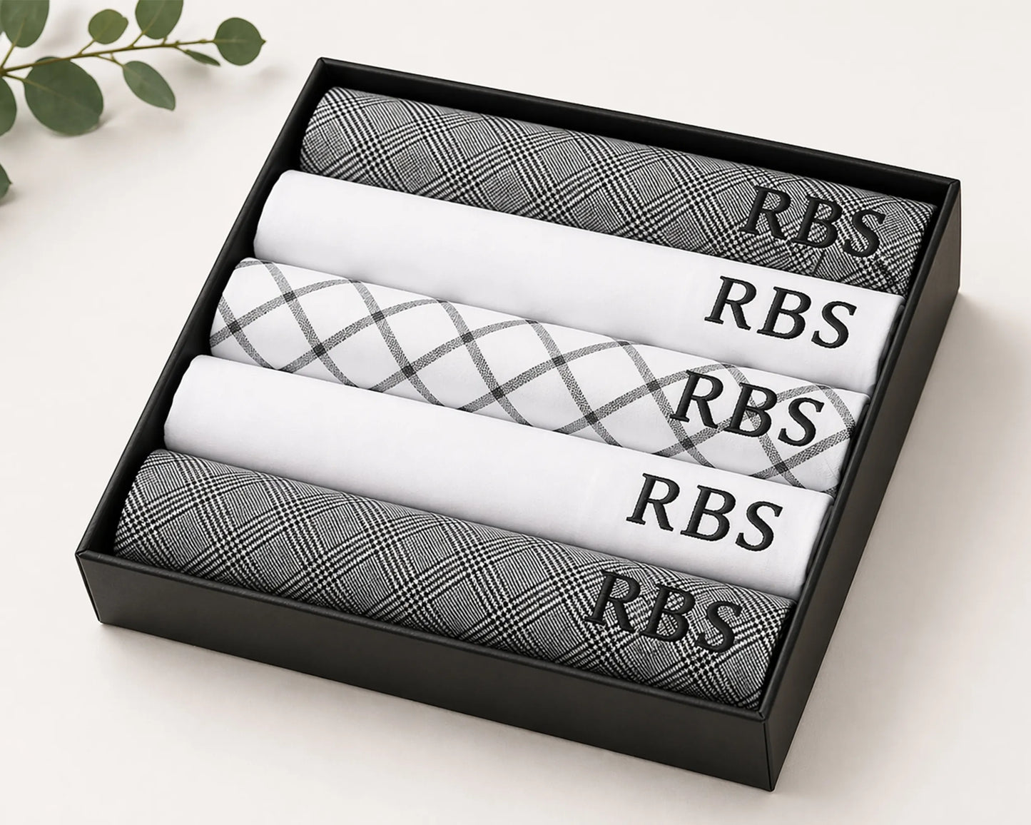 Set of folded hanky with 'RBS' branding in a black box on a light background