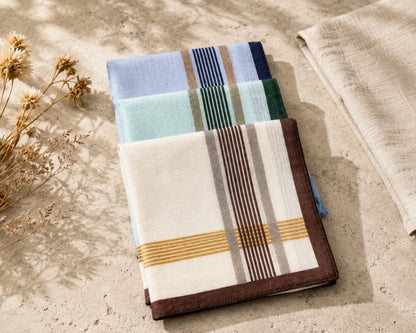 Set of folded hanky with geometric patterns on a textured surface