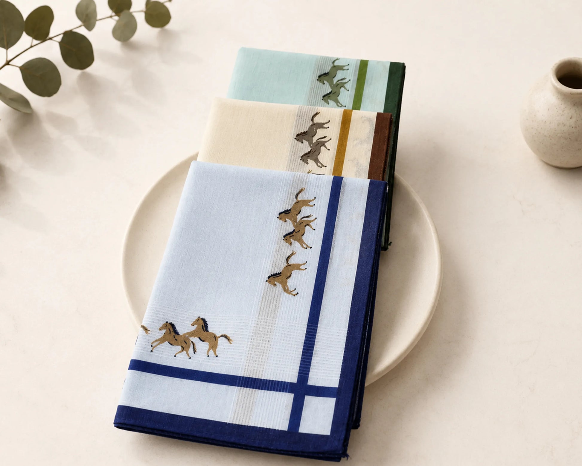Set of folded hanky with horse design on a plate