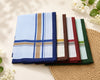 Set of folded plaid hanky in various colors on a textured surface with flowers.