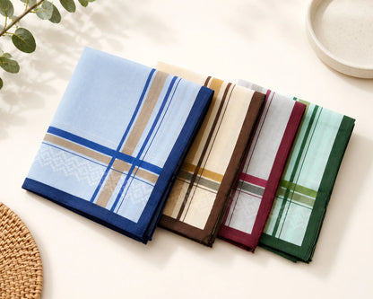 Set of four plaid handkerchiefs in different colors on a light surface.