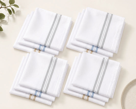 Set of four white hanky with blue and gold stripes on a beige surface.
