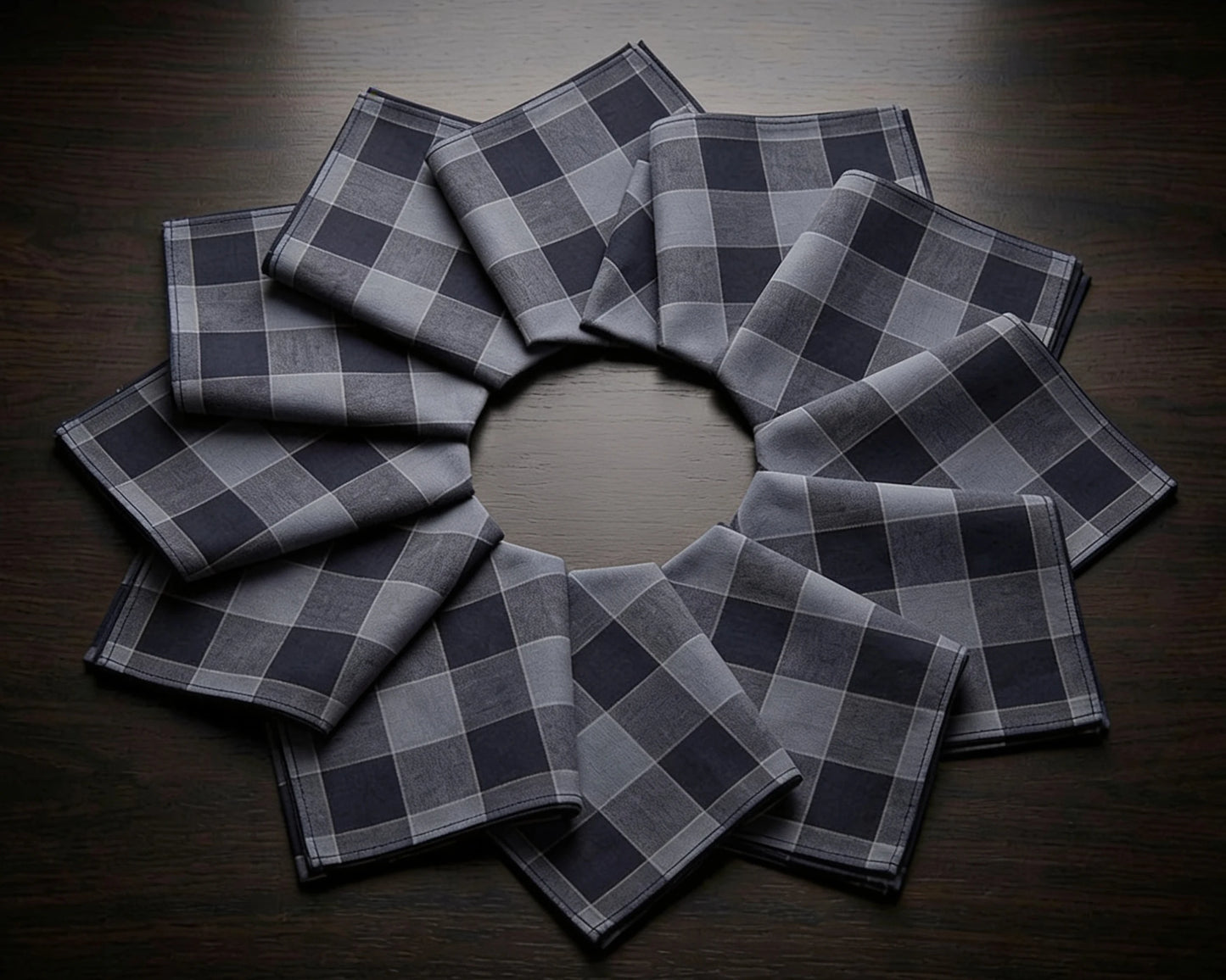 Set of gray checkered hanky arranged in a circular pattern on a wooden surface.