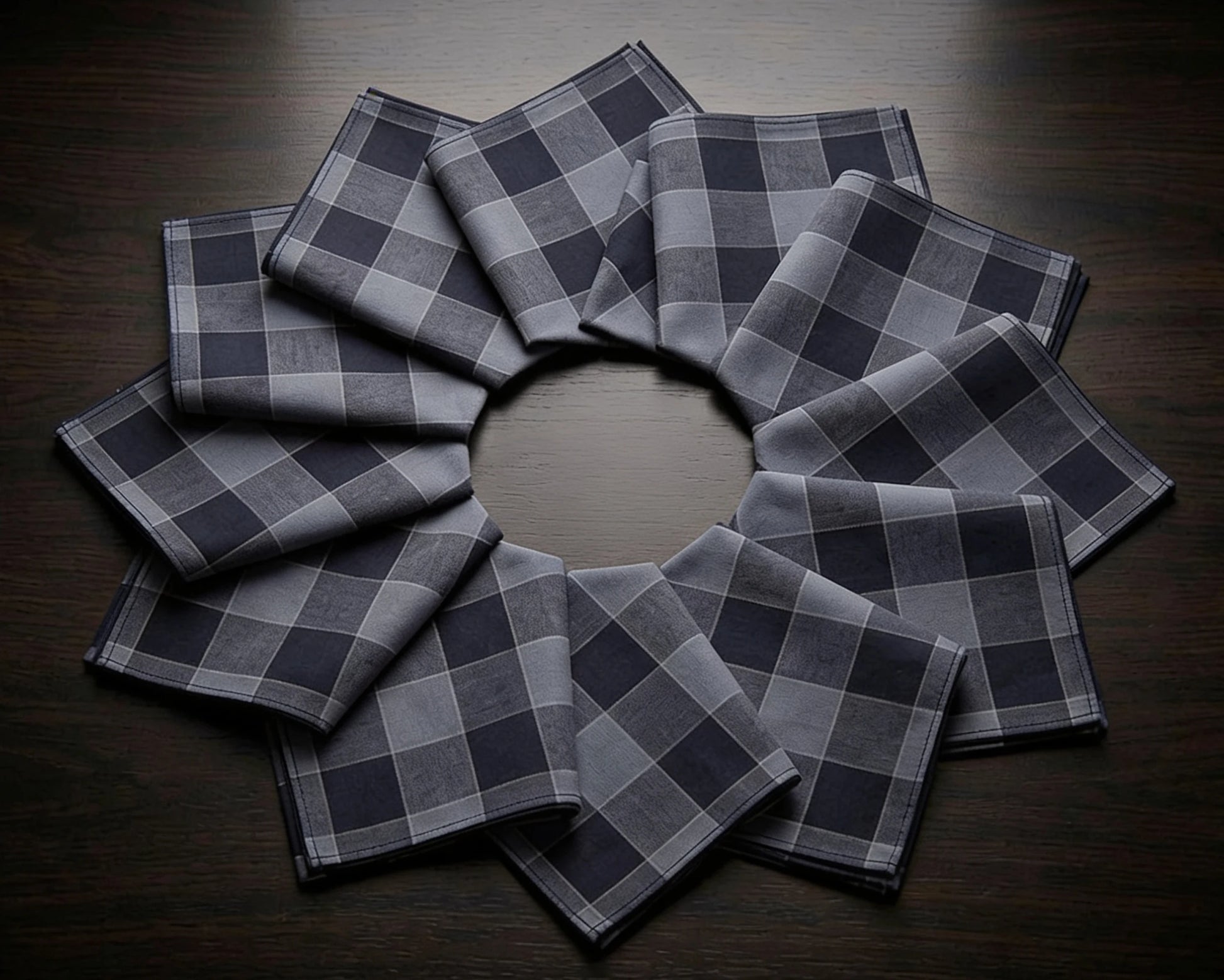 Set of gray checkered hanky arranged in a circular pattern on a wooden surface.