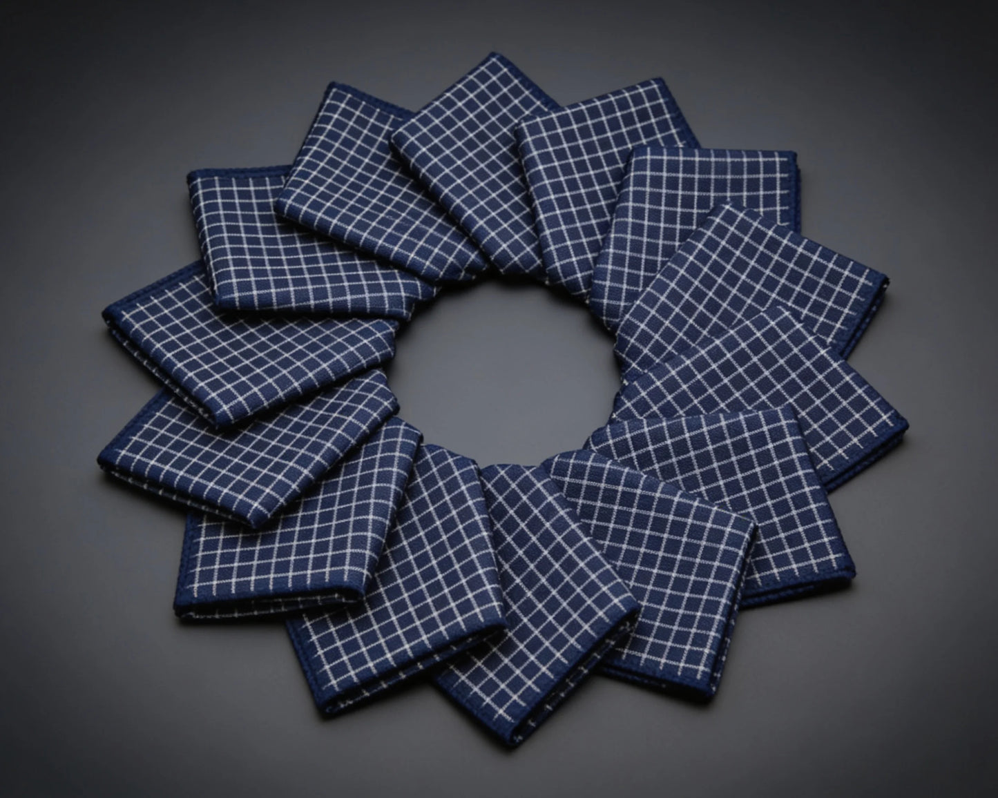 Set of gray checkered hanky arranged in a circular pattern on a wooden surface.