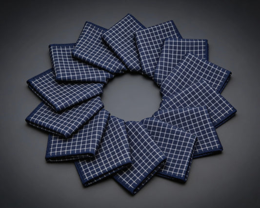 Set of gray checkered hanky arranged in a circular pattern on a wooden surface.
