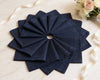 Set of navy blue hanky folded in a decorative pattern on a light background.
