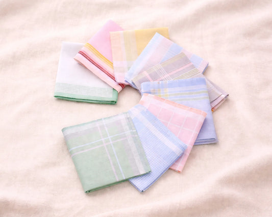 Set of pastel-colored handkerchiefs arranged in a circular pattern on a light background.