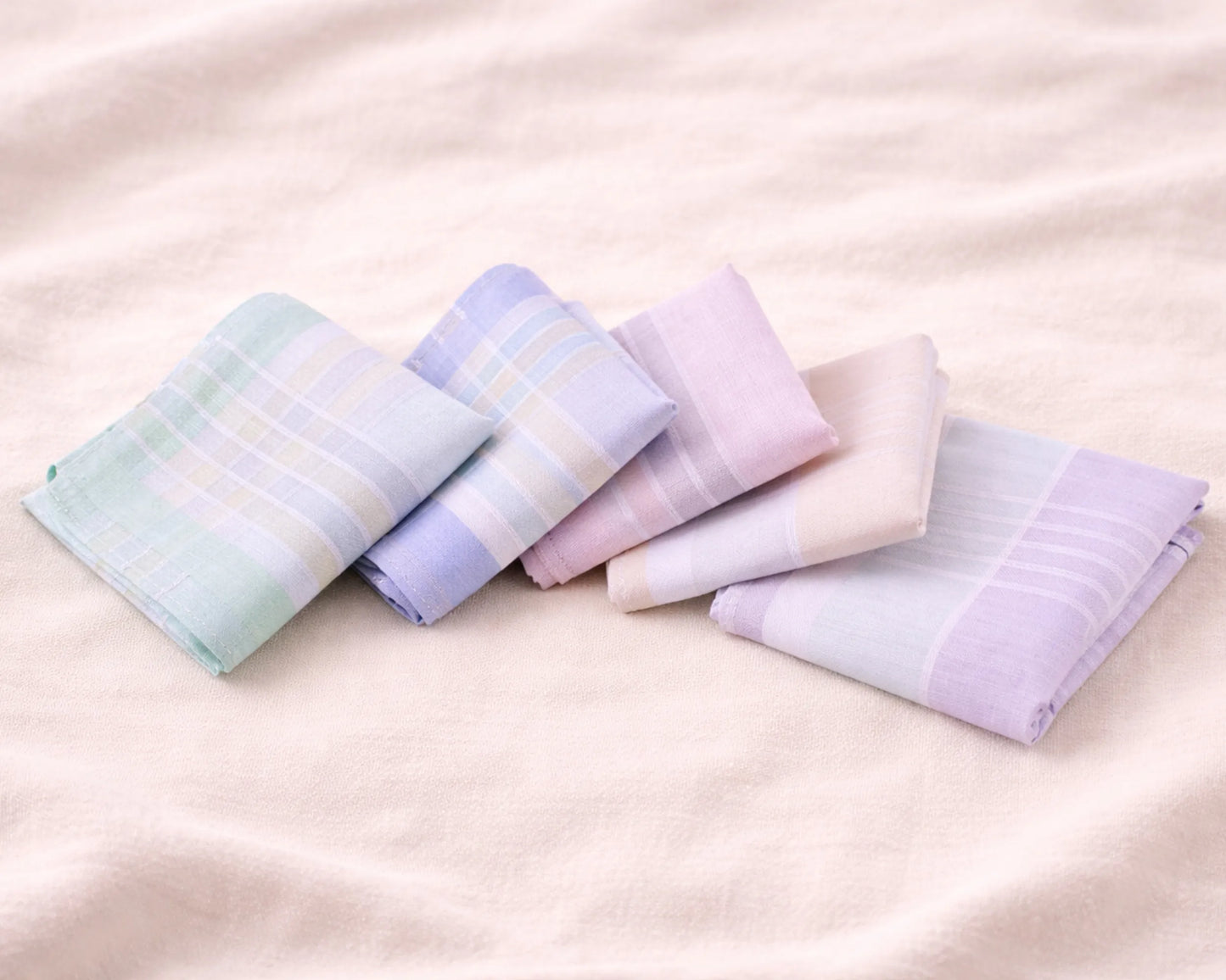 Set of pastel-colored hanky on a soft pink background