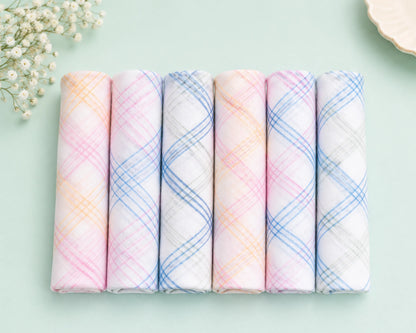 Set of pastel-colored plaid cotton  hanky on a light green background with small flowers.