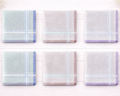 Set of six plaid handkerchiefs in pastel colors on a white wooden background