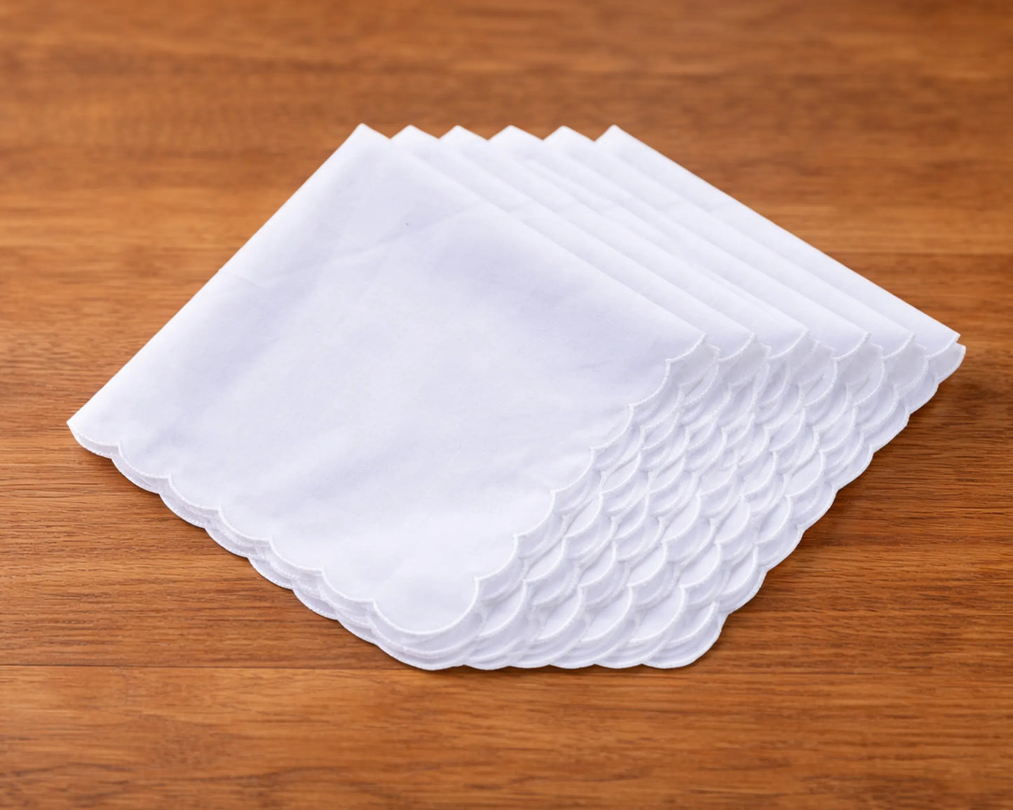 Set of white handkerchiefs on a wooden surface