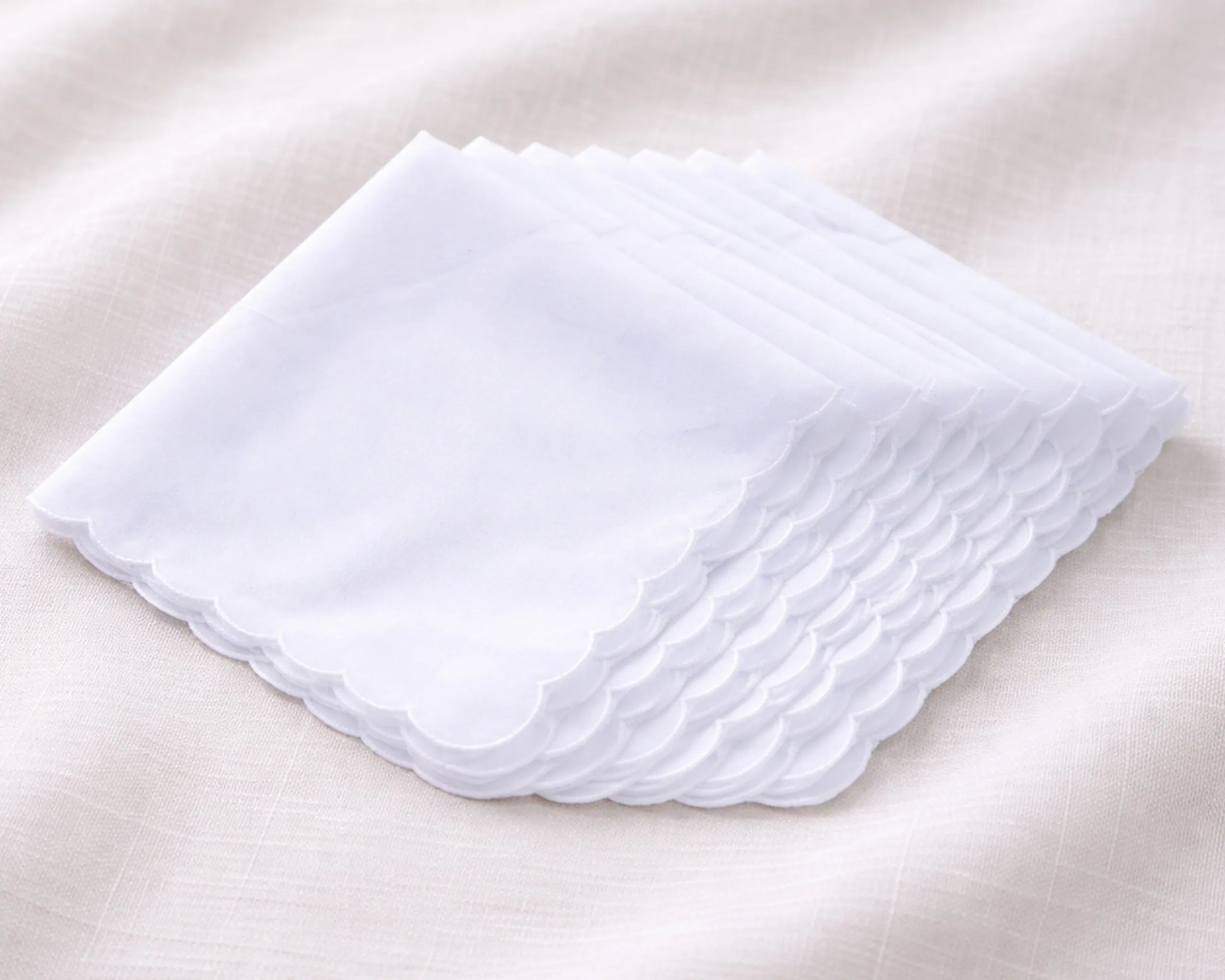 Set of white handkerchiefs on a beige background