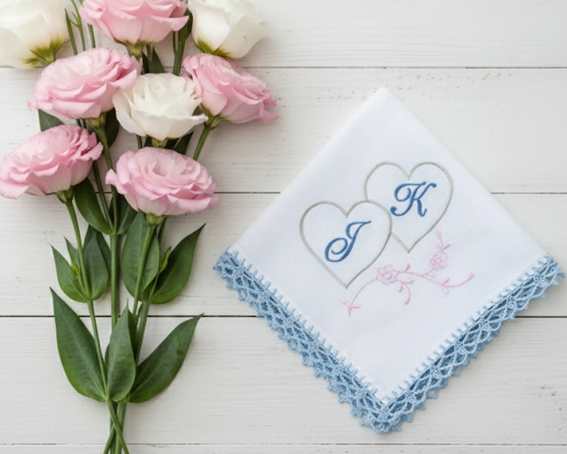 White cotton handkerchief for women showing a blue embroidered letter A with floral vine details and scalloped lace