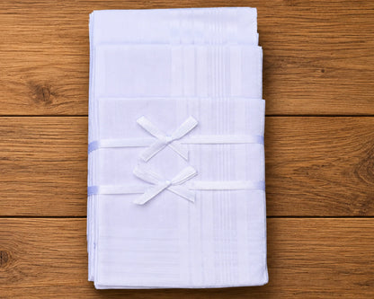 Stack of white folded hanky on a wooden surface