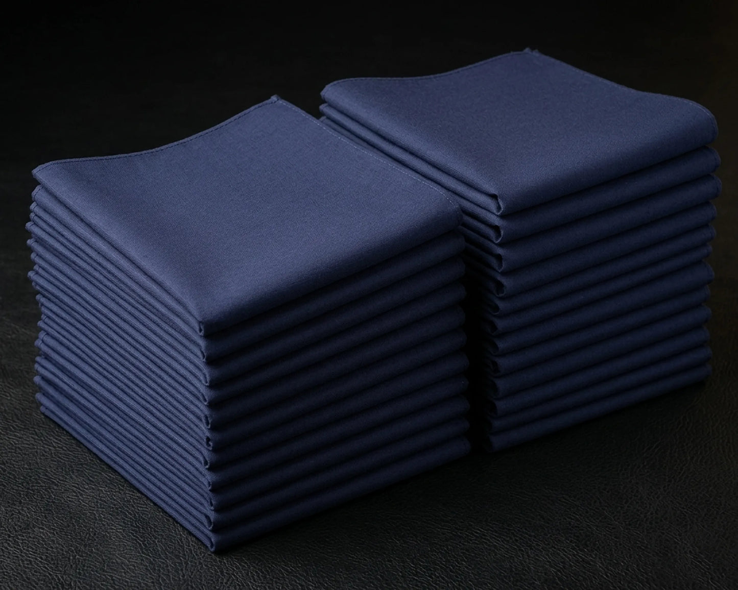 Stack of blue folded hanky on a dark background