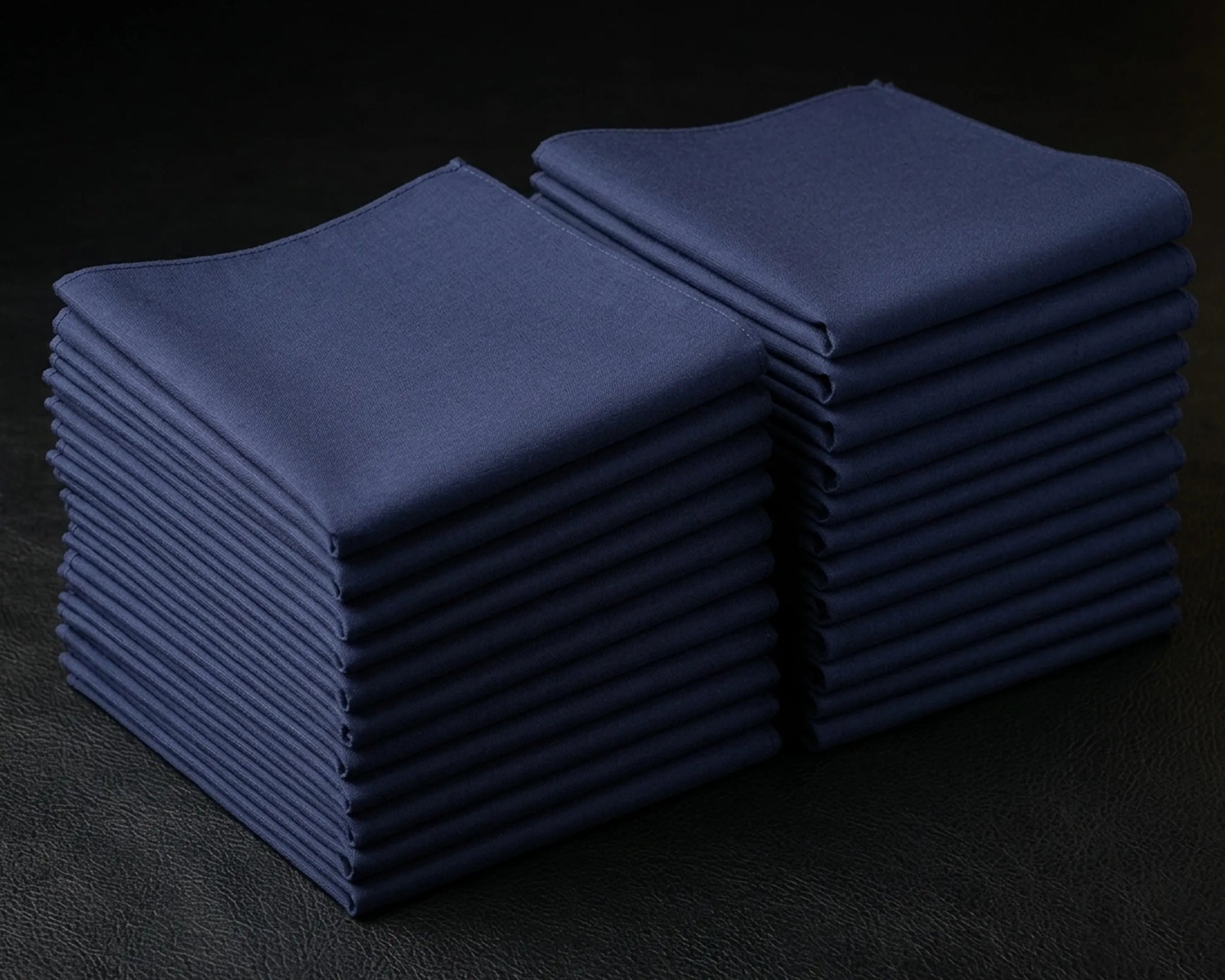 Stack of blue folded hanky on a dark background