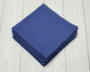 Stack of blue hanky on a light wooden surface