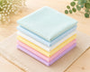 Stack of colorful hanky on a wooden surface with a natural background